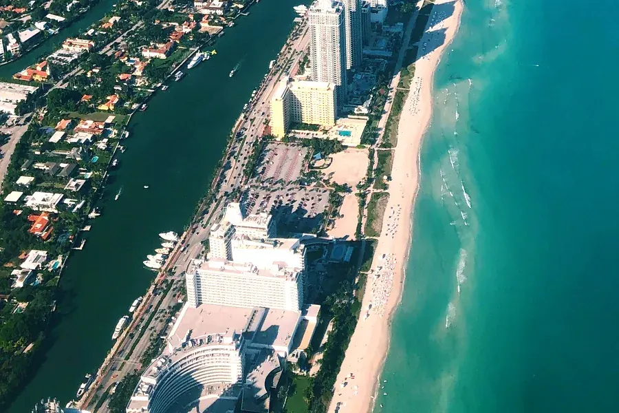 South Beach Miami hotel strip and turquoise ocean aerial view